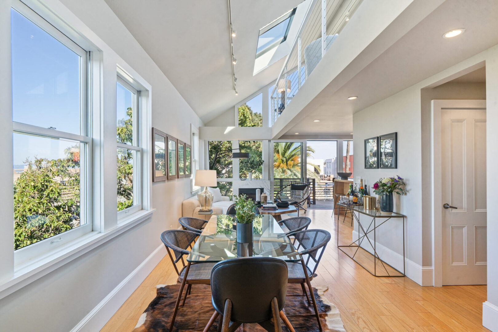 A dining room with a glass table and chairs.